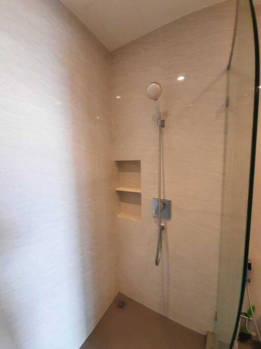 Modern bathroom shower area with built-in shelves