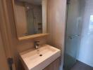 Modern bathroom with a wooden vanity and glass shower