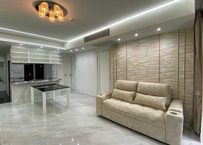 Modern living room with sofa, dining table, and ceiling lights