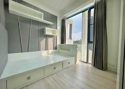Modern bedroom with built-in storage and large window