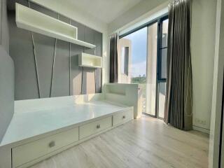 Modern bedroom with built-in storage and large window