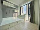 Modern bedroom with built-in storage and large window