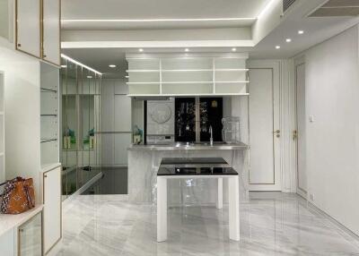 Modern kitchen with white cabinetry and marble flooring