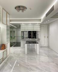 Modern kitchen with white cabinetry and marble flooring