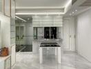 Modern kitchen with white cabinetry and marble flooring