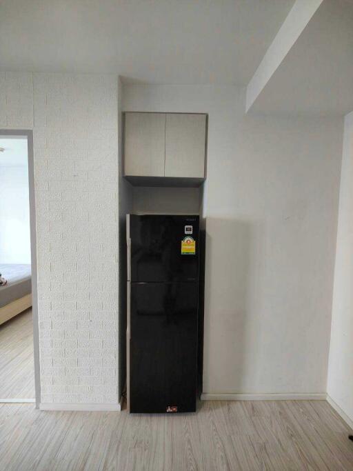 Modern kitchen with black refrigerator and white cabinetry