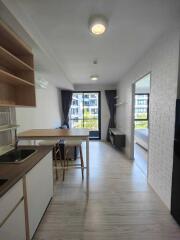 Modern kitchen and living space with balcony view