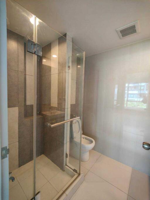 Modern bathroom with glass shower and tiled walls