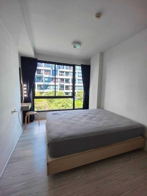 Bedroom with large window and simple furnishings