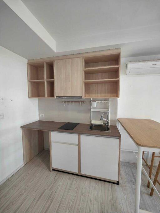 Modern compact kitchen with wooden shelves and countertop