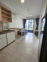 Modern living area with open kitchen and balcony