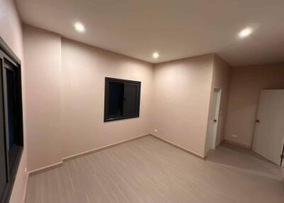 Empty bedroom with tiled floor and recessed lighting