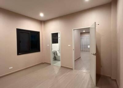 Spacious bedroom with an ensuite bathroom and modern recessed lighting