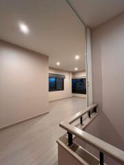 Spacious main living area with large windows and modern lighting