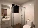 Modern bathroom with shower, sink, and toilet