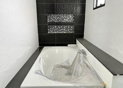 Modern bathroom with bathtub and decorative tiles