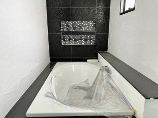 Modern bathroom with bathtub and decorative tiles