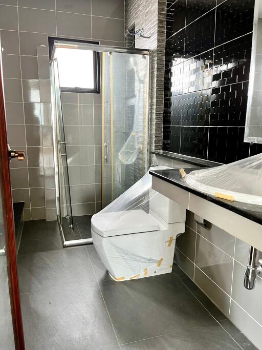 Modern bathroom with a shower enclosure, toilet, and sink