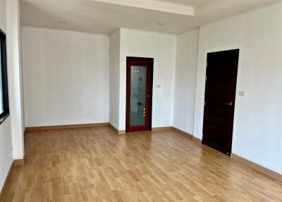 Unfurnished living room with wooden floor and white walls