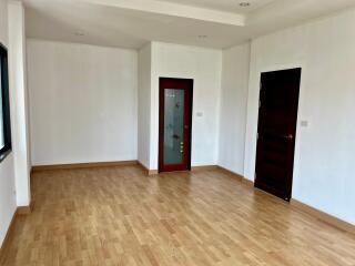 Unfurnished living room with wooden floor and white walls