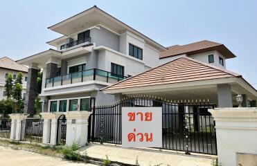 Modern three-story house with a gated entrance