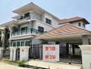 Modern three-story house with a gated entrance