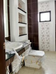 Bathroom with modern design featuring wall shelves and decorative tiles