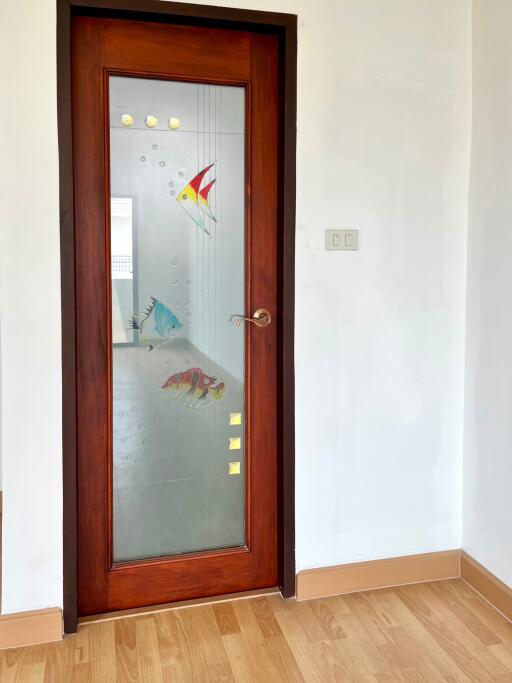 Main door with frosted glass and fish decorations