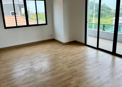 Unfurnished bedroom with wooden floor and large windows