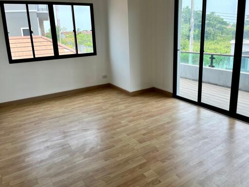 Unfurnished bedroom with wooden floor and large windows