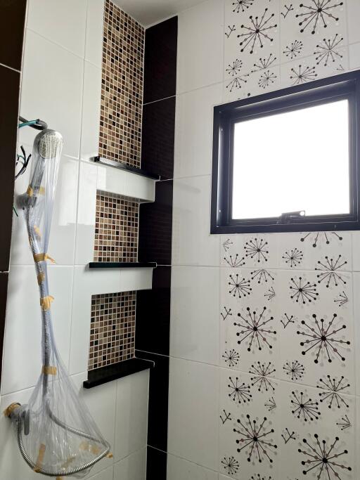 modern bathroom with mosaic tile accents and large window