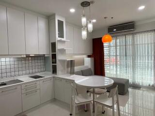 Modern kitchen with dining area and large window