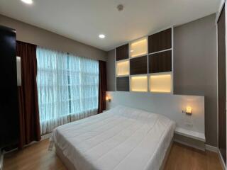 Modern bedroom with large window and decorative lighting