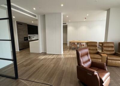 Modern living room with wooden floors and leather recliner chairs