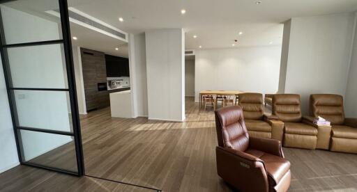 Modern living room with wooden floors and leather recliner chairs