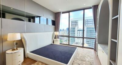 Modern bedroom with large window and city view