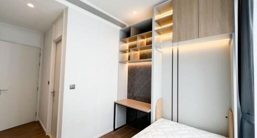 Modern bedroom with built-in storage and study area