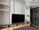 Modern bedroom with built-in wall unit and TV