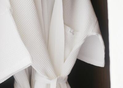 White bathrobe hanging in a wardrobe