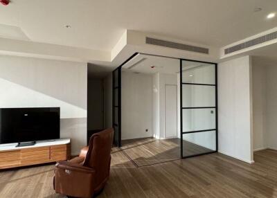 Modern living room with large TV and glass partition