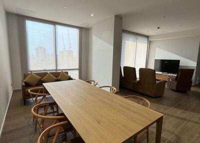 Spacious living room with dining area and large windows