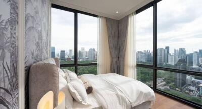 Modern bedroom with large windows offering a city view