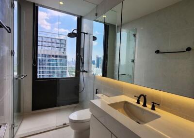 Modern bathroom with large window, shower, and vanity