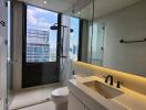 Modern bathroom with large window, shower, and vanity