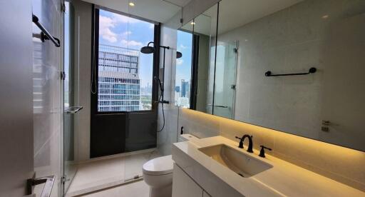 Modern bathroom with large window, shower, and vanity