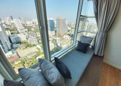 Stunning city view from a high-rise window seat with cushions