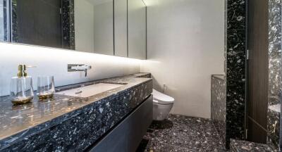 Modern bathroom with marble countertop and integrated sink