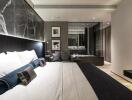 Modern, well-lit bedroom with a large bed, elegant decorations, and a sleek design