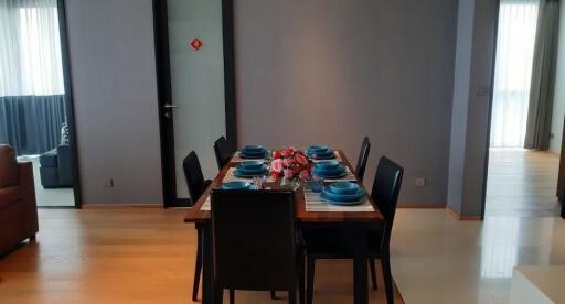 Dining area with table and chairs set up for a meal