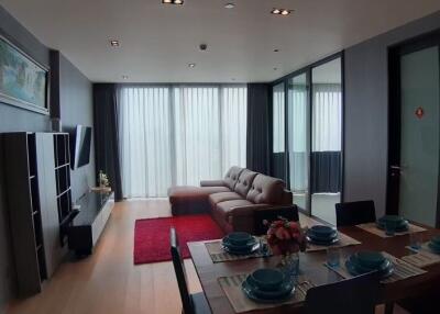 Modern living room with dining area and large windows